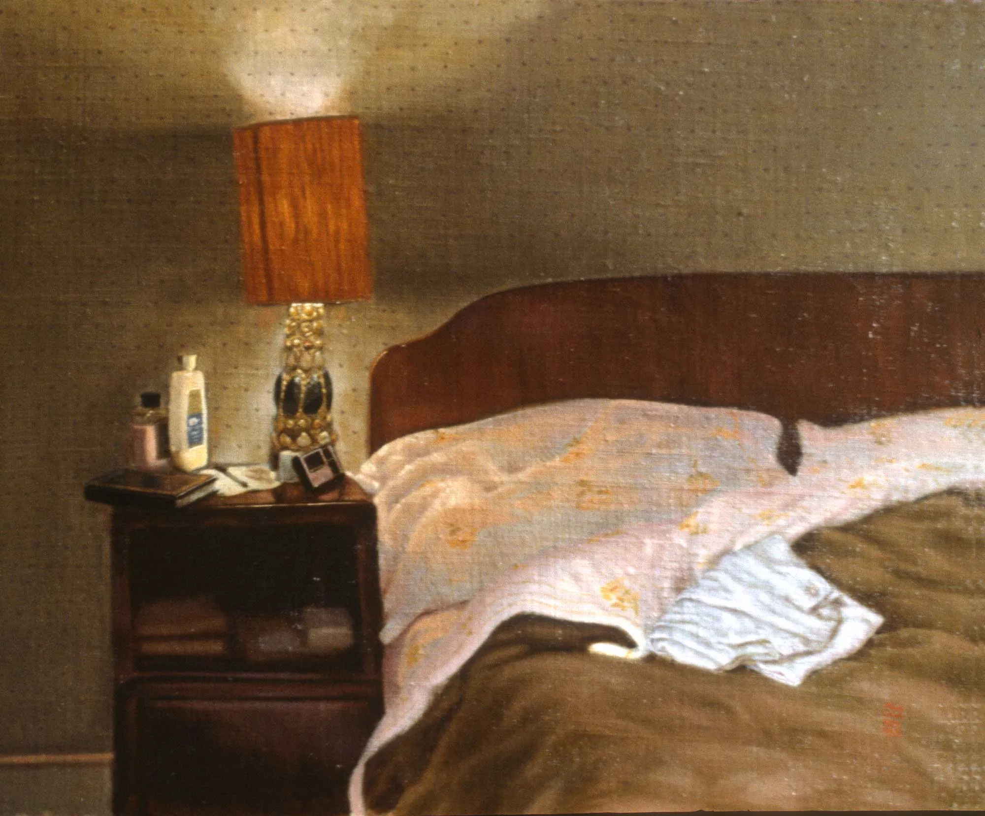 A scene of a bedroom illuminated by a bedside lamp. 
