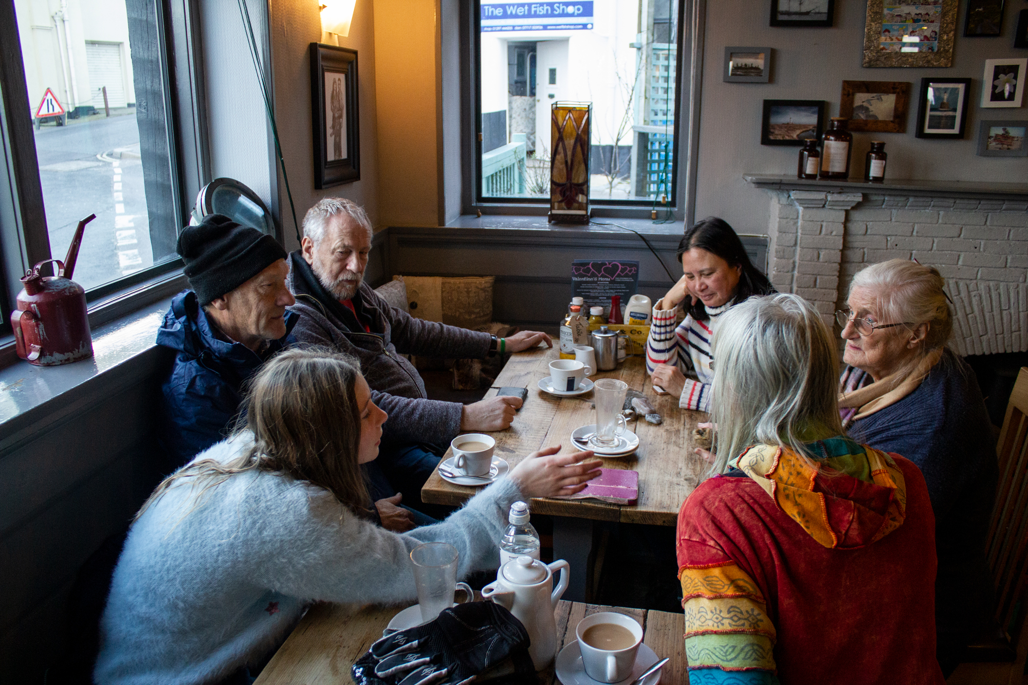 Group sitting around a wooden tabel in a pub.