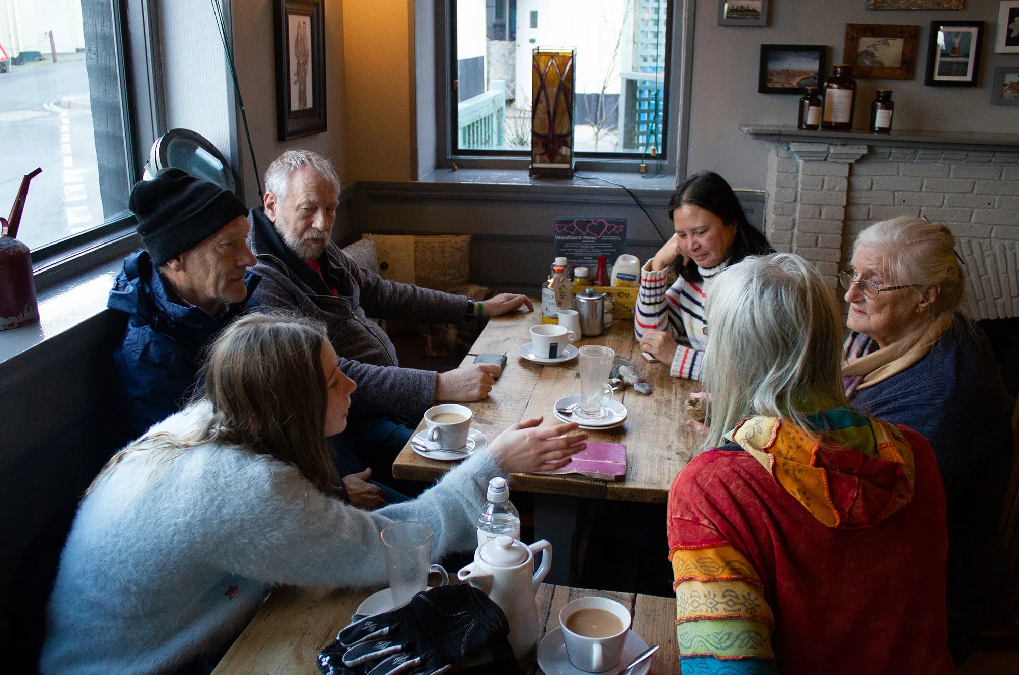 A group of walkers sit around a table in a pub.