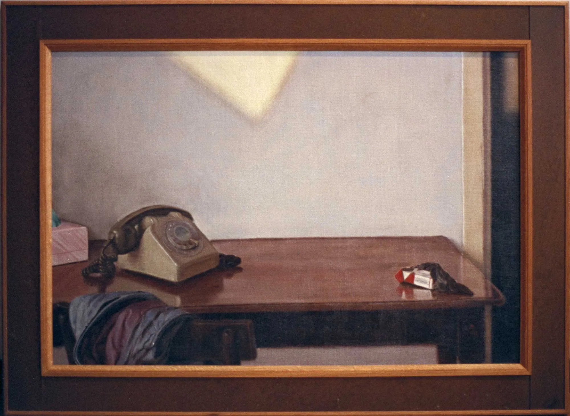 Telephone on a table with sunlight on a wall.