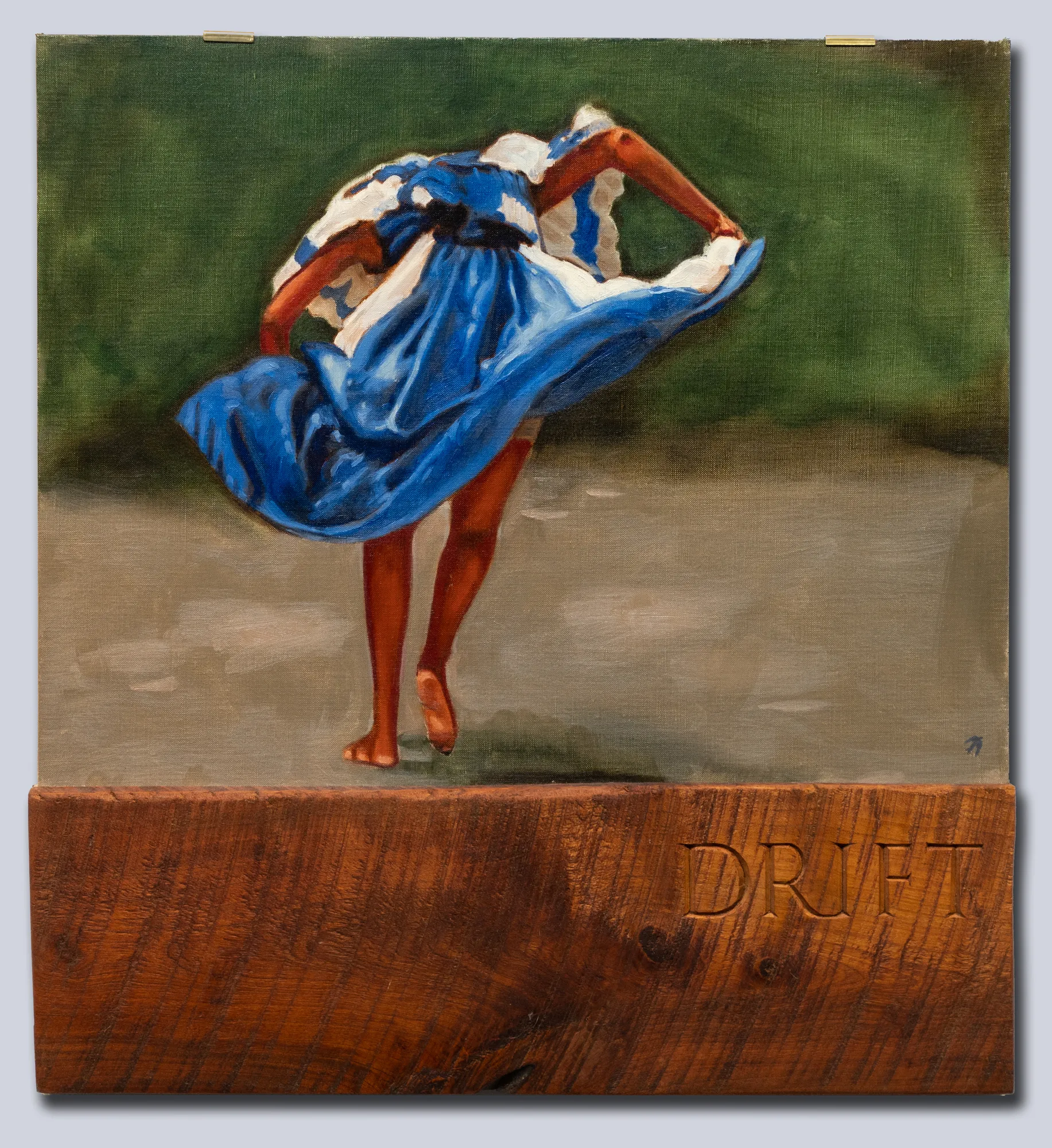 A back of a women dancing, her arms elbow out, head down. Below is a length of wood with Drift carved into it.