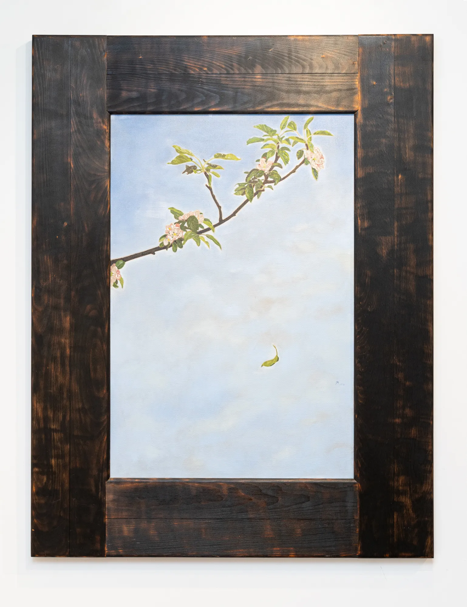 A tree branch and one leaf falling.