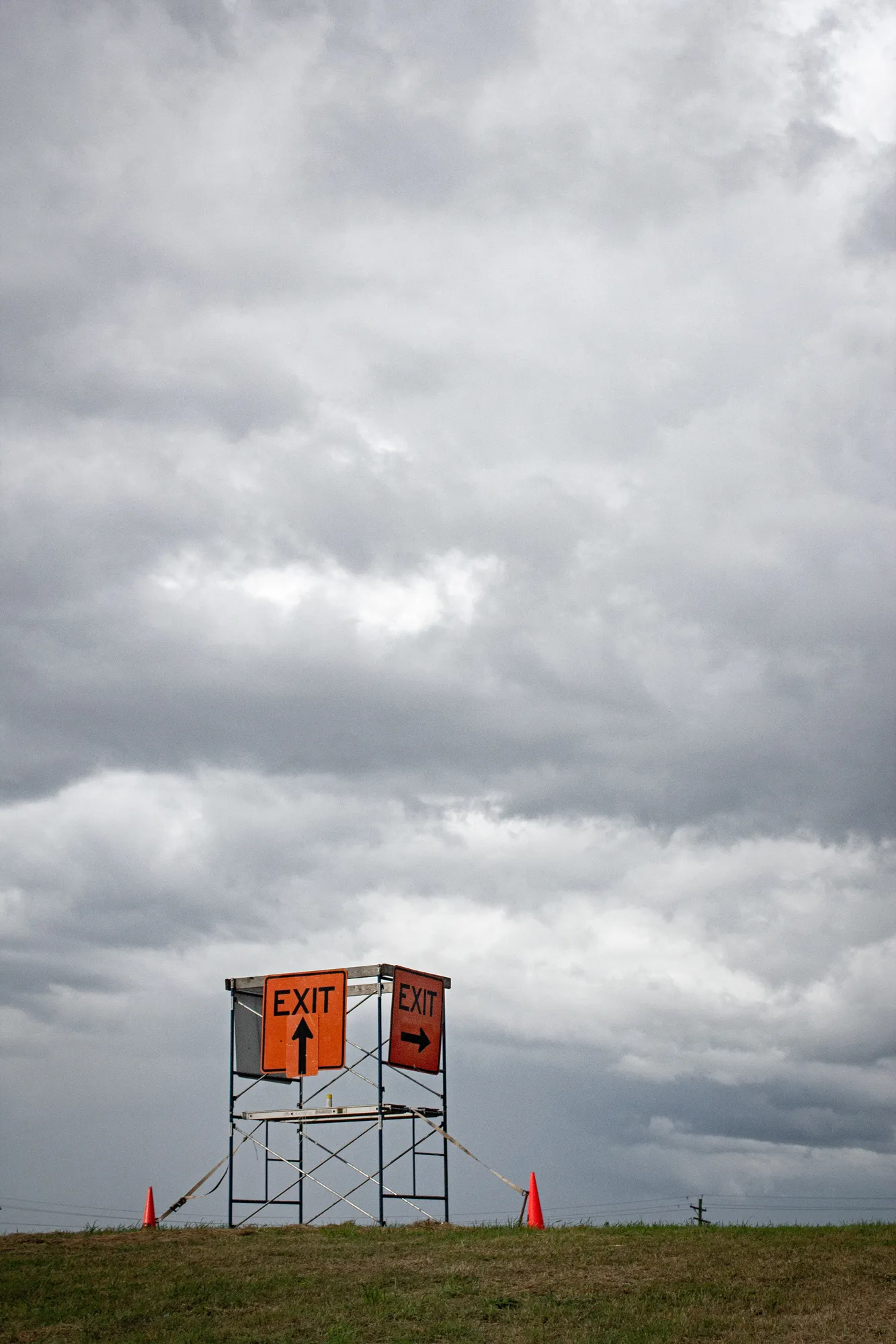 A sign on a scaffolding in a field.