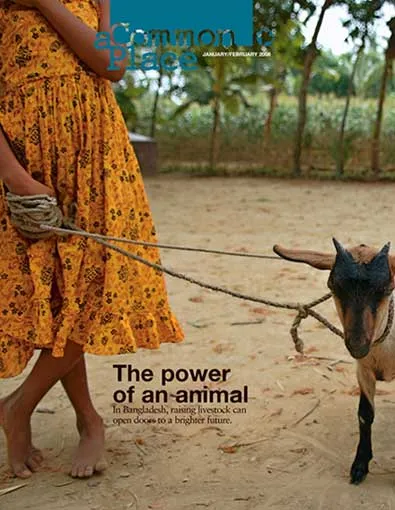 The torso of a young girl holding a small goat by some twine.