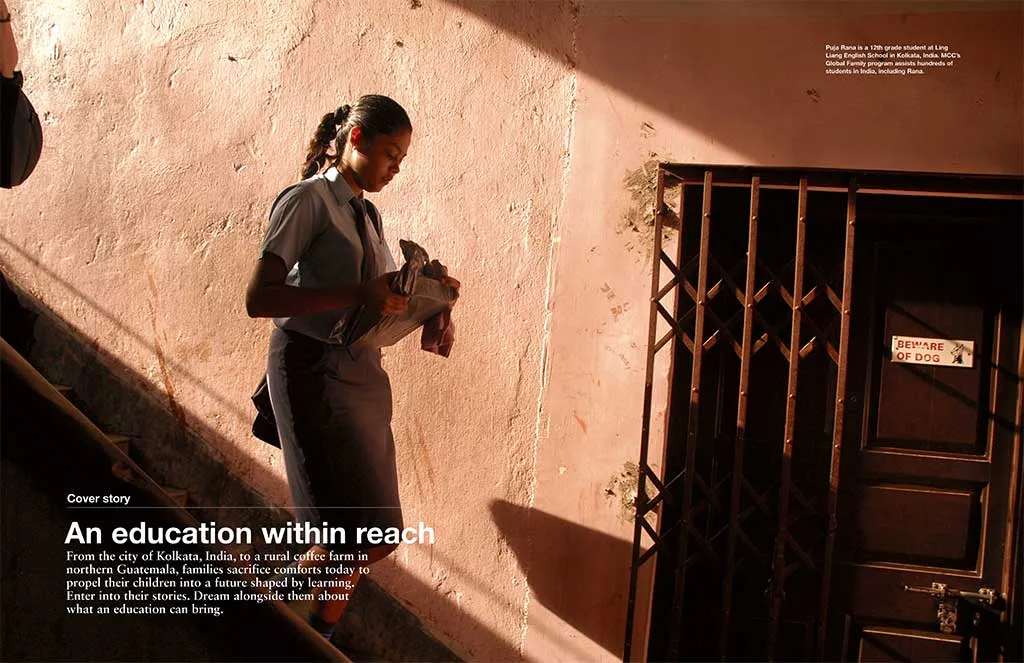 A young women walks down a stairs carrying books